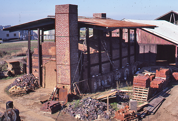 View of the Hidden Brick Company brickyard showing a rectangular kiln and plant buildings.